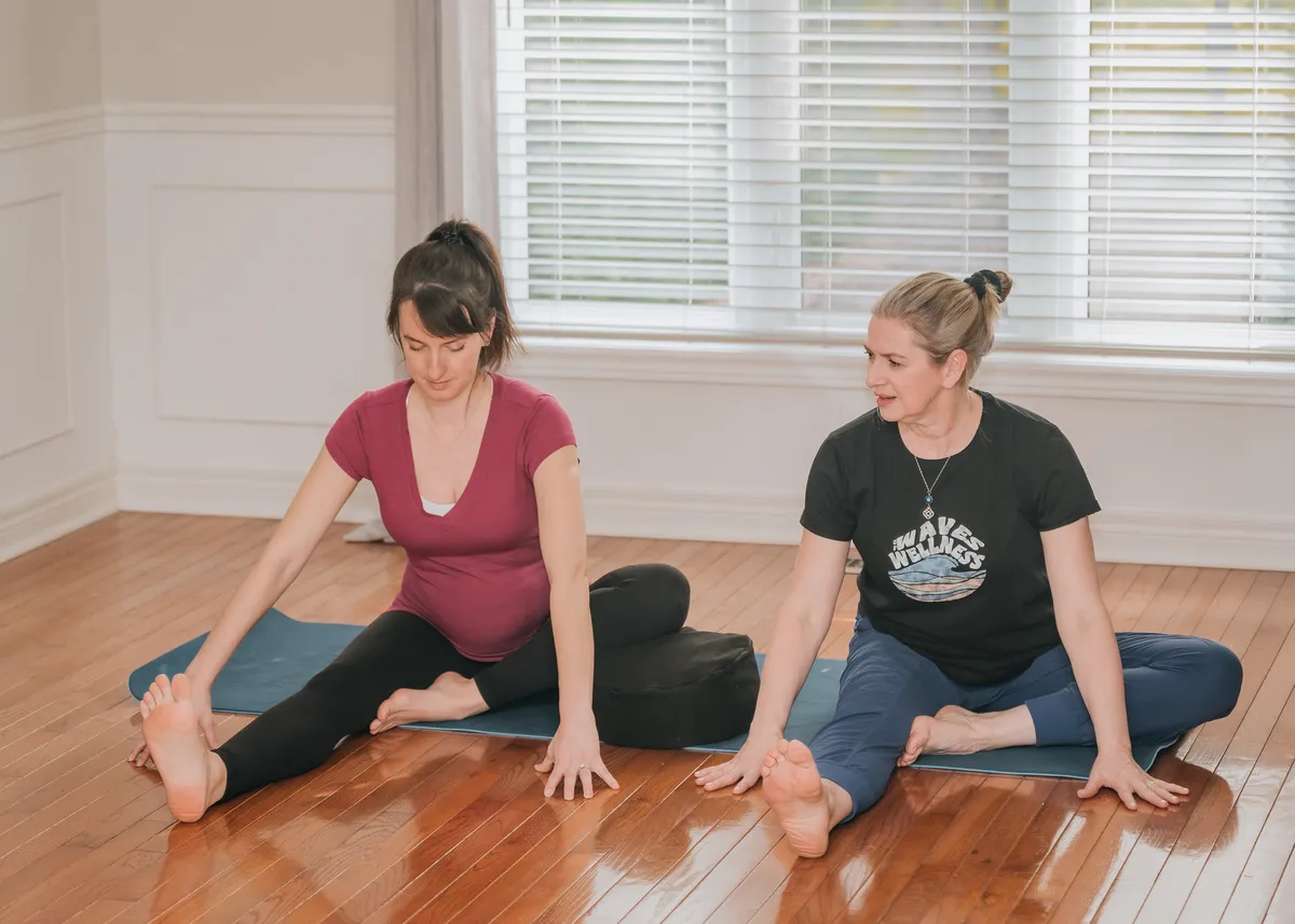 Susan practicing yoga with a pregnant woman